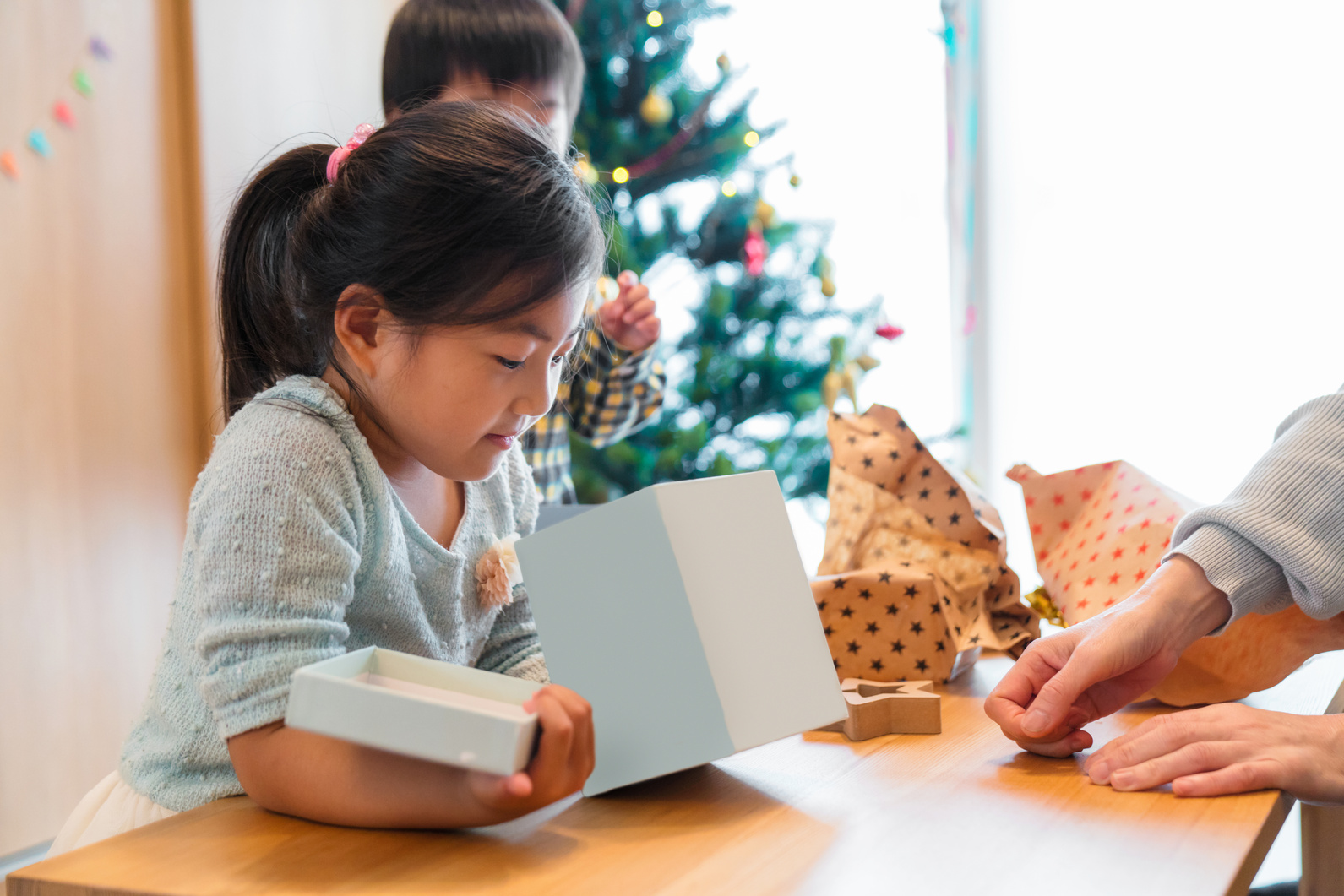 Young children opening their Christmas presents